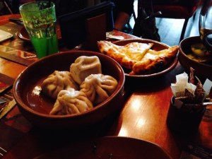 Chingale (ital. cinghiale), filled pasta in the foreground, khachapuri, Georgian pizza behind